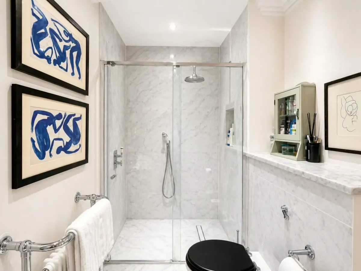 Marble-tiled shower room with glass screen