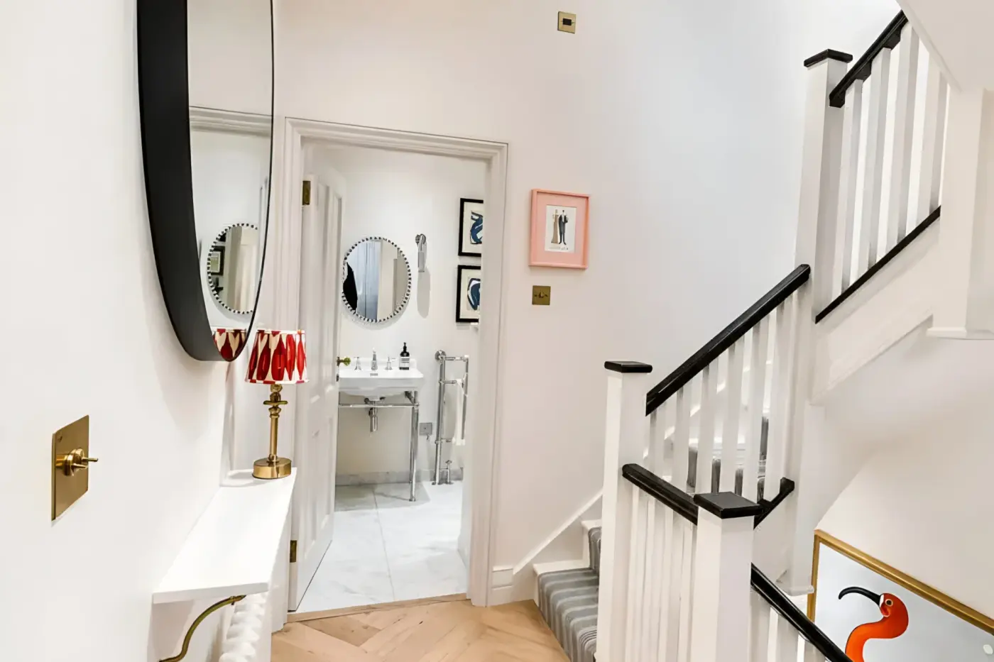 White hallway with painted staircase and cloakroom