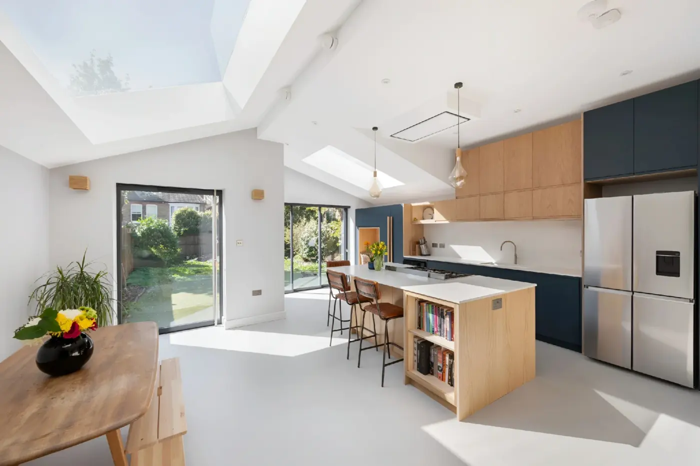 Kitchen island with oak cabinetry and blue units