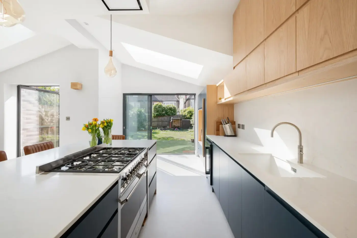 Long kitchen worktop with range cooker under a sloped ceiling