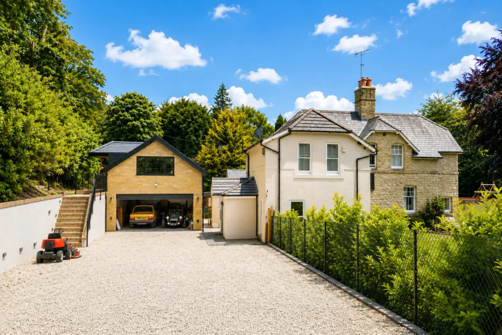 New double garage with a room above, next to a renovated stone house