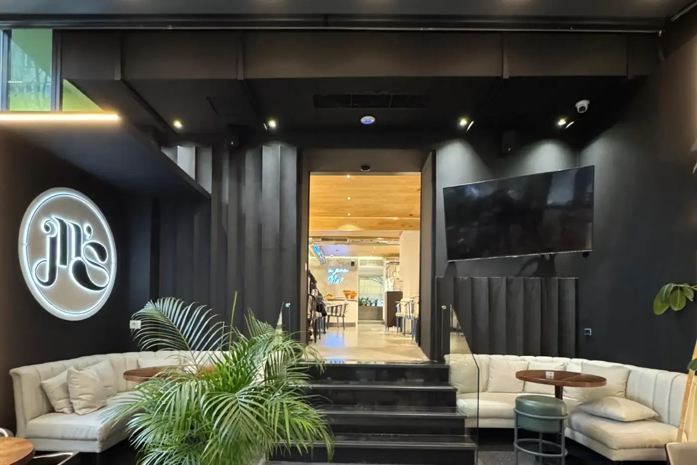 Restaurant interior fit-out with dark panelling and lounge seating